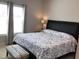 Bedroom featuring a tufted headboard, side table with lamps, and window at 149 Steep Rock Dr, Willow Springs, NC 27592