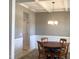 Elegant dining area featuring wainscoting, coffered ceiling, and a stylish chandelier for formal gatherings at 149 Steep Rock Dr, Willow Springs, NC 27592