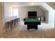 Well-lit game room featuring a pool table, bar stools, and entertainment area with a TV at 149 Steep Rock Dr, Willow Springs, NC 27592
