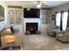 Bright living room featuring a fireplace, built-in shelving, and a comfortable seating area at 149 Steep Rock Dr, Willow Springs, NC 27592