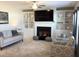 Inviting living room with a cozy fireplace, built-in shelving, and comfortable seating at 149 Steep Rock Dr, Willow Springs, NC 27592