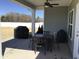Covered patio with a ceiling fan, a dining table and chairs, plus two grills for outdoor cooking at 149 Steep Rock Dr, Willow Springs, NC 27592