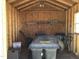 The interior of the storage shed is well organized, with shelving and tools at 149 Steep Rock Dr, Willow Springs, NC 27592