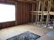 Unfinished attic space showing exposed beams, subflooring and natural light from the window at 149 Steep Rock Dr, Willow Springs, NC 27592