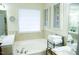 Relaxing bathroom with a soaking tub and natural light at 1516 Bradsher Dr, Stem, NC 27581