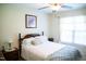 Inviting bedroom with a ceiling fan, white curtains, and neatly made bed with blue accents at 1516 Bradsher Dr, Stem, NC 27581