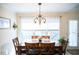 Dining room features a decorative chandelier and lots of light from a nearby window at 1516 Bradsher Dr, Stem, NC 27581