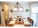 Dining room with a chandelier, floral decorations, and a coordinated dining set at 1516 Bradsher Dr, Stem, NC 27581