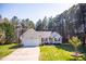 Charming single-story home with red shutters, attached garage, and manicured lawn at 1516 Bradsher Dr, Stem, NC 27581