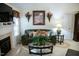 Bright living room with fireplace and large sofa at 1516 Bradsher Dr, Stem, NC 27581