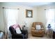 Cozy living room featuring two recliners with throw pillows, side tables, and natural lighting at 1516 Bradsher Dr, Stem, NC 27581