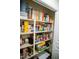 Pantry featuring organized shelves filled with a variety of canned goods and household staples at 1516 Bradsher Dr, Stem, NC 27581