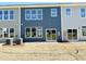 Spacious backyard featuring sod, sliding glass doors, and ample natural light at 162 Nimble Way # 225, Clayton, NC 27520