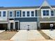 Modern townhomes featuring a two-car garage, concrete driveway and manicured landscaping at 162 Nimble Way # 225, Clayton, NC 27520
