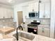 Bright kitchen featuring granite countertops, stainless steel appliances, and stylish backsplash at 162 Nimble Way # 225, Clayton, NC 27520