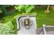 An aerial view of the back patio shows a table and chairs overlooking lush landscaping, blending outdoor living at 1721 Frenchwood Dr, Raleigh, NC 27612