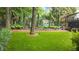 Landscaped backyard features lush green lawn, decorative statues, and mature trees for privacy and beauty at 1721 Frenchwood Dr, Raleigh, NC 27612