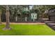 Well-manicured backyard with artificial turf, statues, and a charming playhouse, perfect for outdoor enjoyment at 1721 Frenchwood Dr, Raleigh, NC 27612