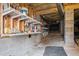 Unfinished basement area with shelving and visible ductwork, offering potential for storage or customization at 1721 Frenchwood Dr, Raleigh, NC 27612