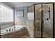Bright bathroom featuring a soaking tub and a frameless glass shower at 1721 Frenchwood Dr, Raleigh, NC 27612