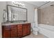 Bathroom with granite countertops, dual sinks, a soaking tub with shower, and neutral tile flooring at 1721 Frenchwood Dr, Raleigh, NC 27612
