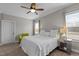 Light-filled bedroom with neutral decor, a ceiling fan, and large windows for natural light at 1721 Frenchwood Dr, Raleigh, NC 27612