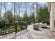 Elevated wood deck overlooking a well-maintained yard with mature trees and a comfortable seating area at 1721 Frenchwood Dr, Raleigh, NC 27612
