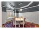 Dining room showcasing detailed trim work, modern chandelier, and hardwood floors at 1721 Frenchwood Dr, Raleigh, NC 27612