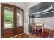 A dining room features a table set for four under a modern light fixture at 1721 Frenchwood Dr, Raleigh, NC 27612