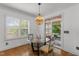 Dining area with a glass table and natural light coming in from a sliding glass door at 1721 Frenchwood Dr, Raleigh, NC 27612