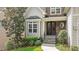 Inviting entrance with a stone porch, a dark wooden door, and decorative landscaping at 1721 Frenchwood Dr, Raleigh, NC 27612