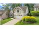 Charming two-story home with an attached garage, manicured lawn, and beautiful landscaping at 1721 Frenchwood Dr, Raleigh, NC 27612