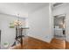 Bright hallway features hardwood floors, a chandelier, and wrought iron railing at 1721 Frenchwood Dr, Raleigh, NC 27612