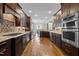 Spacious kitchen with dark wood cabinets, stainless steel appliances, and hardwood floors at 1721 Frenchwood Dr, Raleigh, NC 27612