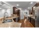 Kitchen featuring dark wood cabinetry, granite countertops, and stainless steel appliances at 1721 Frenchwood Dr, Raleigh, NC 27612
