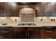 Close-up of kitchen area with granite countertops, tile backsplash, and gas cooktop at 1721 Frenchwood Dr, Raleigh, NC 27612