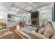 Open living room with coffered ceilings, stone fireplace, and seamless flow to the kitchen at 1721 Frenchwood Dr, Raleigh, NC 27612