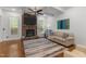Bright living room features stone fireplace, coffered ceiling, and a ceiling fan at 1721 Frenchwood Dr, Raleigh, NC 27612