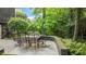 A cozy outdoor patio with a dining table and chairs, surrounded by lush landscaping and greenery at 1721 Frenchwood Dr, Raleigh, NC 27612