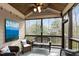 Relaxing screened-in patio featuring comfortable wicker furniture and serene wooded views at 1721 Frenchwood Dr, Raleigh, NC 27612