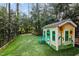 Charming backyard playhouse provides a whimsical retreat for children, surrounded by green space for fun at 1721 Frenchwood Dr, Raleigh, NC 27612