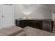 A finished wet bar area featuring dark wood cabinetry, granite countertop, and a beverage refrigerator at 1721 Frenchwood Dr, Raleigh, NC 27612
