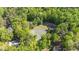 Aerial view of a tennis court nestled within a verdant, tree-lined neighborhood at 1801 Irish Blvd, Sanford, NC 27332