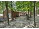 Spacious backyard with mature trees, patio area, and lush greenery at 1801 Irish Blvd, Sanford, NC 27332