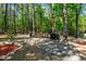 Backyard featuring gravel ground cover, a grill and bordered by woods at 1801 Irish Blvd, Sanford, NC 27332