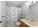 Bathroom featuring a toilet, a sink with a mirror, and a butterfly patterned shower curtain at 1801 Irish Blvd, Sanford, NC 27332