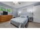 Comfortable bedroom featuring neutral walls, a bed with a floral pattern, and a wood dresser at 1801 Irish Blvd, Sanford, NC 27332