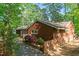 A charming brown wood-sided home with brick foundation surrounded by mature trees at 1801 Irish Blvd, Sanford, NC 27332