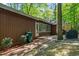 Exterior view of a well-maintained home showcasing lush greenery, wooded views, and peaceful backyard at 1801 Irish Blvd, Sanford, NC 27332