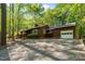Single-story home with attached garage, large driveway, well-kept landscaping and beautiful trees at 1801 Irish Blvd, Sanford, NC 27332